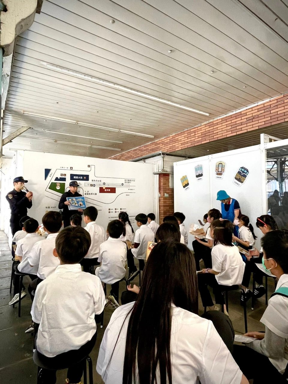 孩子們在車站月台聽站務人員介紹鐵道知識